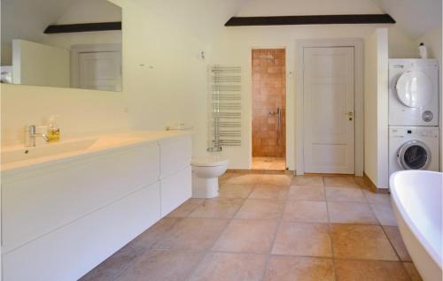 a white bathroom with a sink and a toilet at Venøhus in Venø By