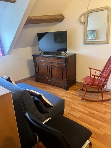 a living room with a couch and a tv at maison de 100 m2 comprenant 3 chambres avec jardin in Dun-sur-Grandry