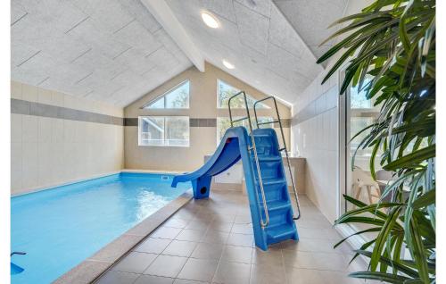 a indoor swimming pool with a slide in a house at Gorgeous Home In Nørre Nebel With Sauna in Nørre Nebel