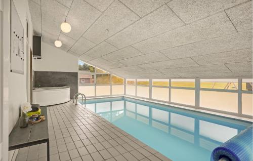 an indoor swimming pool with a swimming pool at Amazing Home In Ebeltoft With Wifi in Ebeltoft