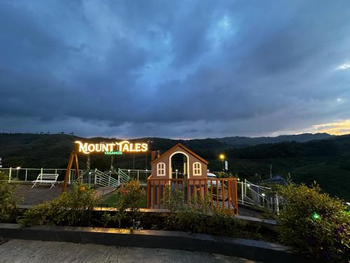 a sign for a mountain cafe with a building at Mount Tales Vagamon in Vagamon