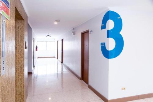 a hallway with a number three sign on the wall at Merlin Hotel in Sungai Kolok