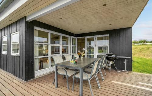 un patio con tavolo e sedie su un ponte di Holiday Home Vinkelbæk Ix a Nordborg