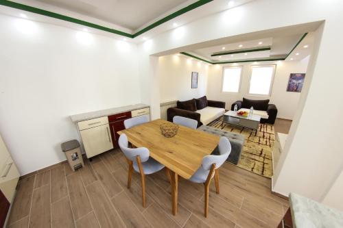 a dining room and living room with a table and chairs at Apartments Villa Begić in Sarajevo