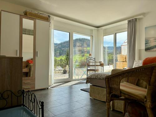 a living room with a view of a mountain at Chez Svanette B&B Villa Sonnglück in Zullwil