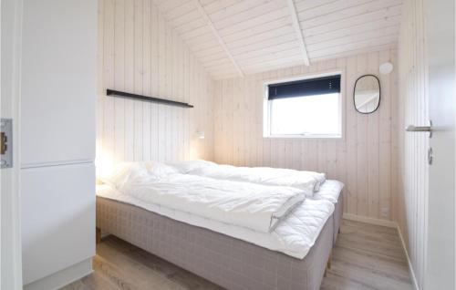 a large bed in a room with a window at Four-Bedroom Holiday Home In Malling in Malling