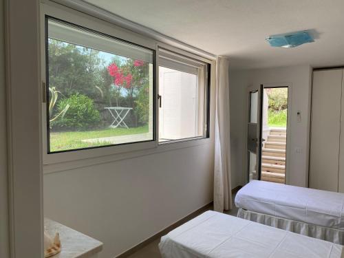 Postel nebo postele na pokoji v ubytování Villa Caroline - Notteri a Villasimius