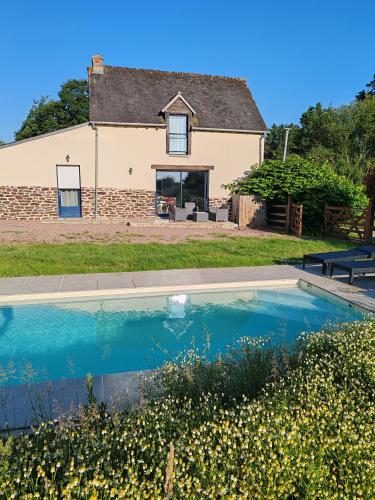 une maison avec une piscine devant une maison dans l'établissement L'Oté de Brekilien, à Saint-Malon-sur-Mel