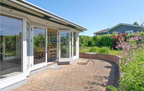 a patio with sliding glass doors and a table at Nice Home In Roskilde With Wifi in Roskilde