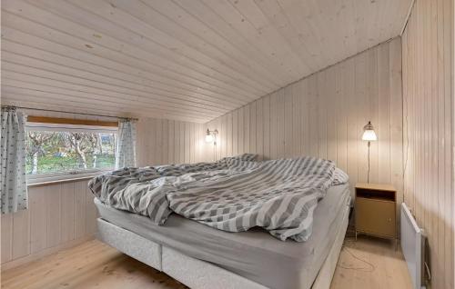 a bed in a white room with a window at Two-Bedroom Holiday Home In Kalundborg in Kalundborg