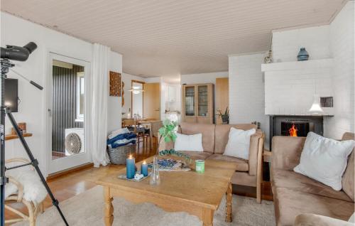 a living room with a couch and a table at 3 Bedroom Awesome Home In Kalundborg in Kalundborg