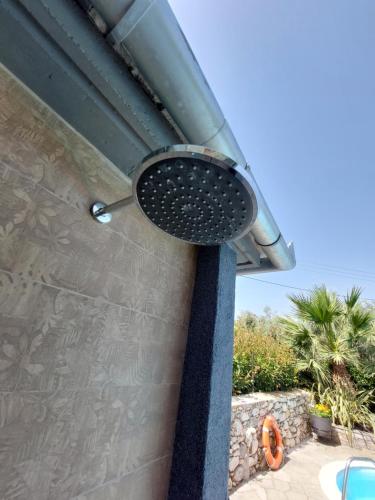 a grill on the side of a house at The Cocoon and olives Hut in Koropi