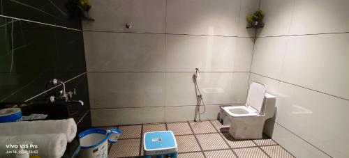 a bathroom with a toilet and a sink at Saanvi Farmhouse in Hampi