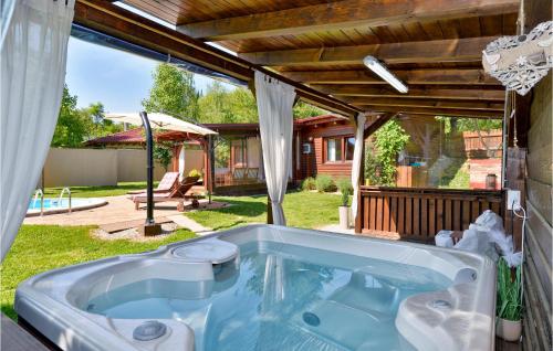 a hot tub in the yard of a house at Amazing Home In Lopatinec With Jacuzzi in Lopatinec