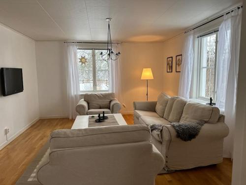 a living room with a couch and a table at Prästgården 303 Västra Tunhem in Västra Tunhem