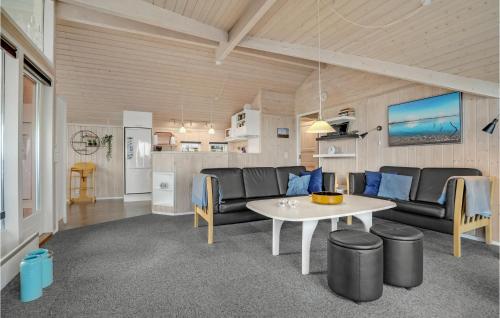 a living room with a couch and a table at Holiday Home Bygmarken V in Sjølund