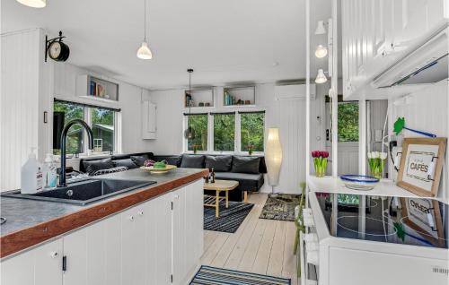 an open kitchen and living room with a couch at 2 Bedroom Amazing Home In Kruså in Kruså