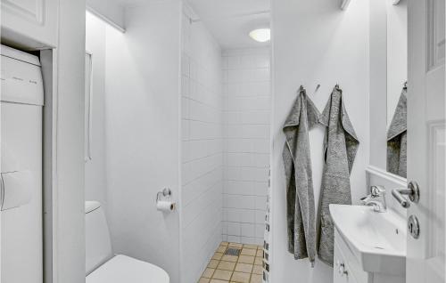 a white bathroom with a toilet and a sink at Apartment Havnevej Nykøbing Sj V in Nykøbing Sjælland