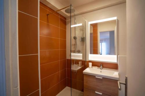 une salle de bain avec un lavabo et une douche en verre dans l'établissement Charmant T2 rénové lumineux à 15mins du vieux port, à Marseille