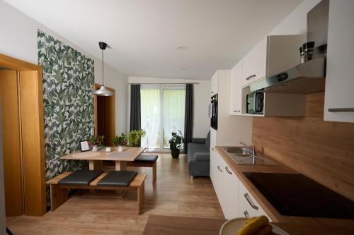 a kitchen with a table and a dining room at Laudach INN in Vorchdorf