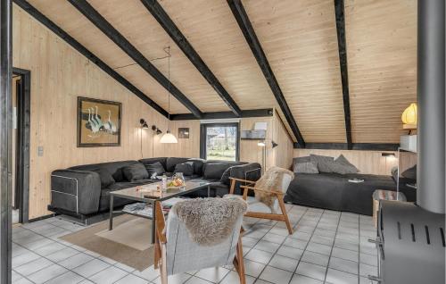a living room with a couch and a table at Holiday Home Syrenvej Tranekær I in Skattebølle