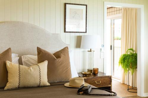 a bedroom with a bed with pillows and a table at Verandah House Country Estate in Mount Tamborine