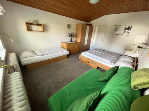 a bedroom with two beds in a room at Chata Ondrášek in Bedřichov