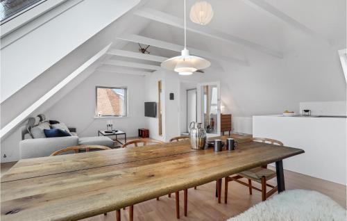 a dining room and living room with a wooden table at 3 Bedroom Stunning Apartment In Hasle in Hasle
