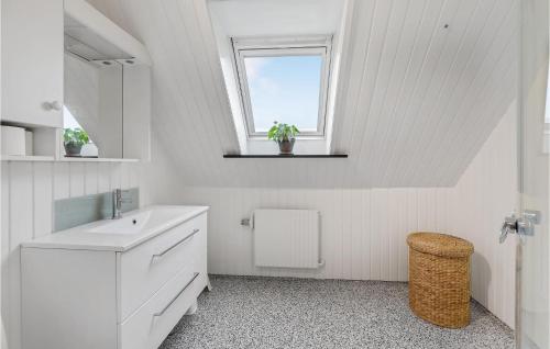 a white bathroom with a sink and a window at 3 Bedroom Stunning Apartment In Hasle in Hasle