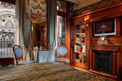 - une chambre avec un lit et une cheminée dans l'établissement Bellevue Luxury Rooms - San Marco Luxury, à Venise