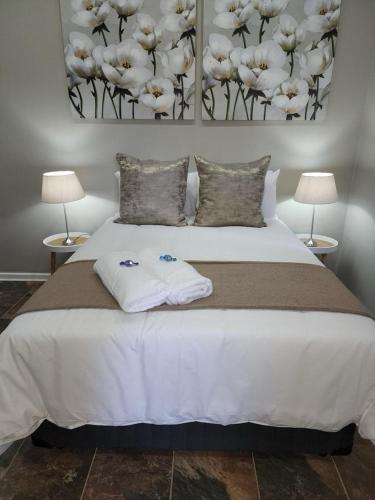 a bedroom with a bed with two towels on it at The Honeycomb 2 in Kimberley