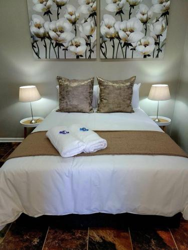 a bedroom with a bed with two towels on it at The Honeycomb 2 in Kimberley