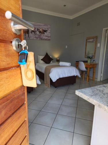 a hotel room with a bed and a kitchen at The Honeycomb 2 in Kimberley