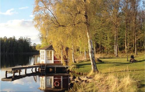 a small house on a dock on a lake at Beautiful Home In Karlskrona With Wifi in Fröbbestorp