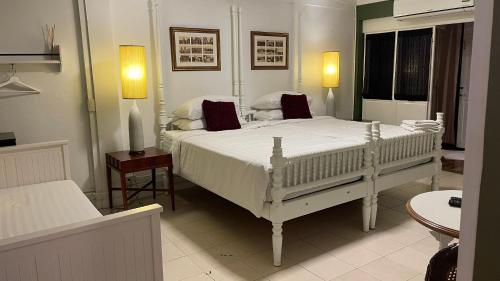 a bedroom with a large white bed in a room at Bed in Town in Chiang Mai