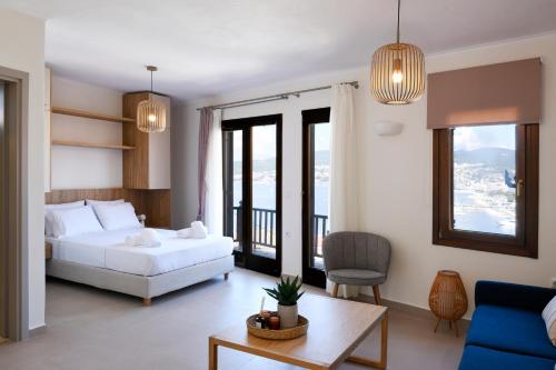 a bedroom with a bed and a living room at ISTIO apartments in Kavála