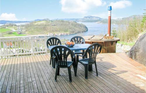 a table and chairs on a deck with a view of the water at Lovely Home In Fister With Wifi in Fister