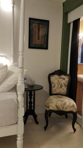 a bedroom with a chair and a table at Bed in Town in Chiang Mai