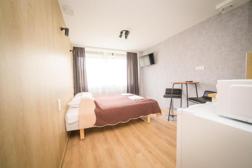 Ένα ή περισσότερα κρεβάτια σε δωμάτιο στο Vilnius Tiny apartments