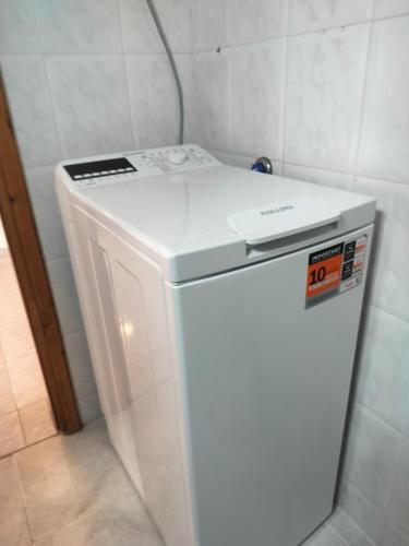 a white refrigerator with a sign on top of it at Pyrgadikia 1BR Welcome stay Private Holiday House in Chalkidiki - Sithonia in Pyrgadikia