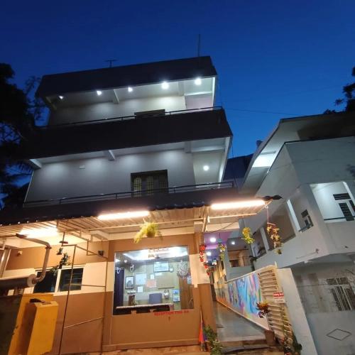 a building with lights on it at night at Sri Murugan Beach Paradise Hotel in Mahabalipuram
