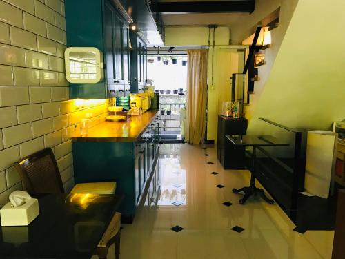 a kitchen with a counter and a table in a room at Bed in Town in Chiang Mai