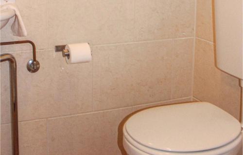 a bathroom with a toilet and a roll of toilet paper at Fonteinbos in Oudemirdum