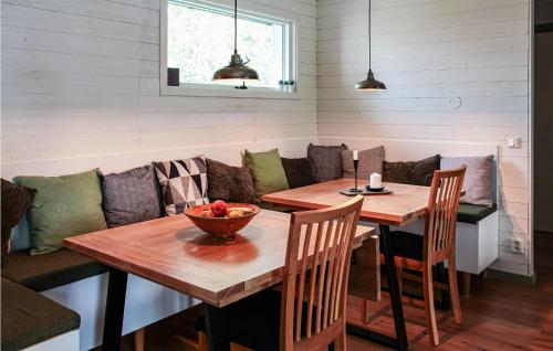 a dining room with a table with a bowl of fruit on it at Stunning Home In Figeholm With Kitchen in Figeholm