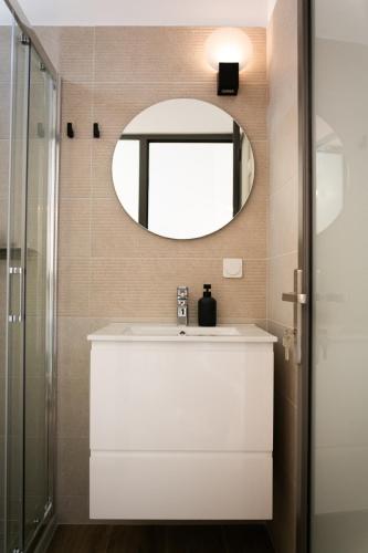 a bathroom with a white sink and a mirror at Physis Fokida in Eratini