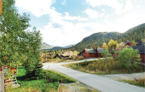 a road leading to a village in the mountains at Nice Home In Hovden With Sauna in Hovden