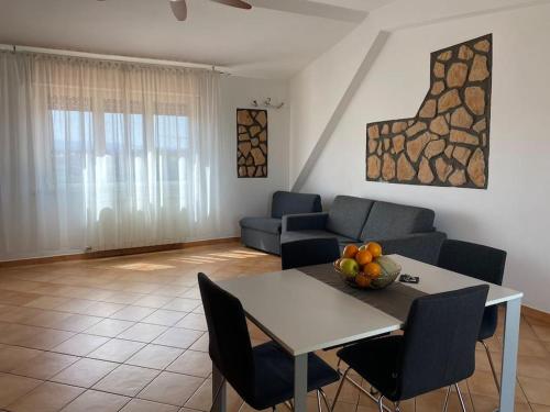 a living room with a table and a couch at Sibilla Tiburtina House Attico Roma con parcheggio in Rome
