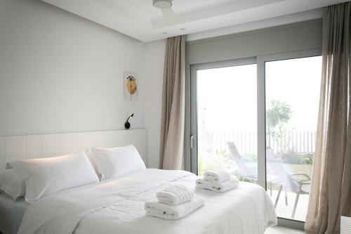a bedroom with a bed with two towels on it at Physis Fokida in Eratini