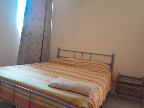 a bedroom with a bed with a blanket on it at Chetty Tourist Residence in Pereybere