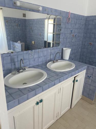 - une salle de bains carrelée de bleu avec deux lavabos et un miroir dans l'établissement Maison DE VACANCES VUE MER PROCHE PLAGE AJACCIO SANGUINAIRES REF 1070, à Ajaccio